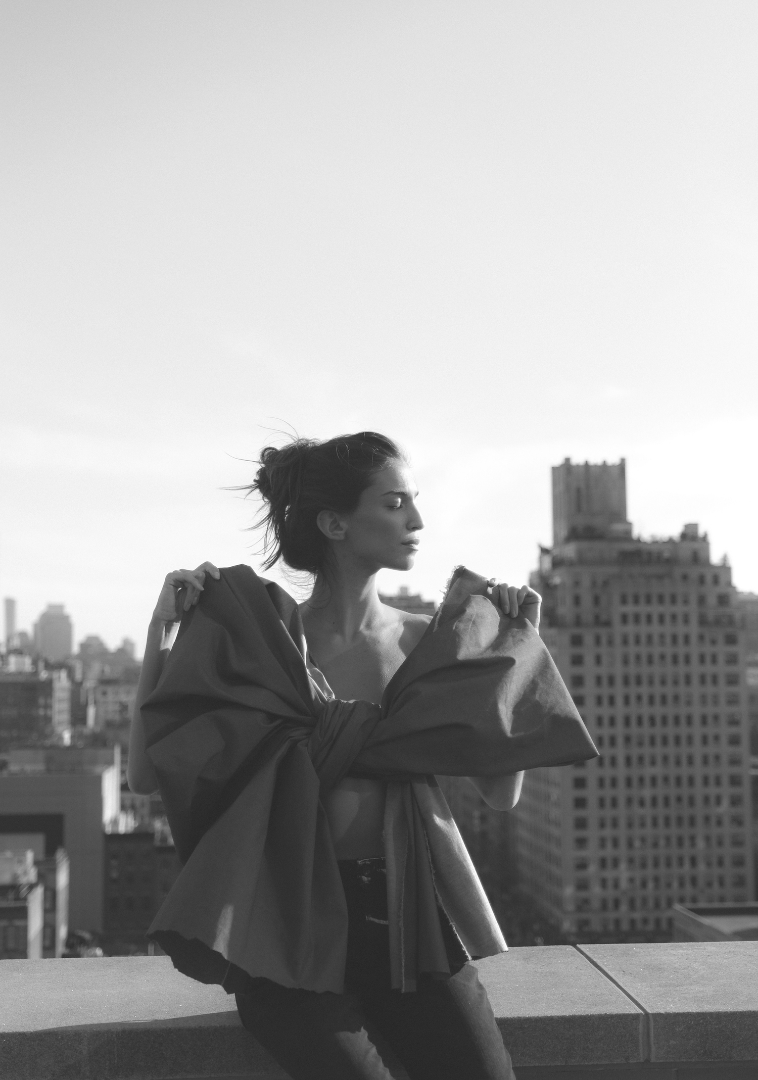 marina testino wrapped in large isko denim bow on rooftop with NYC in background
